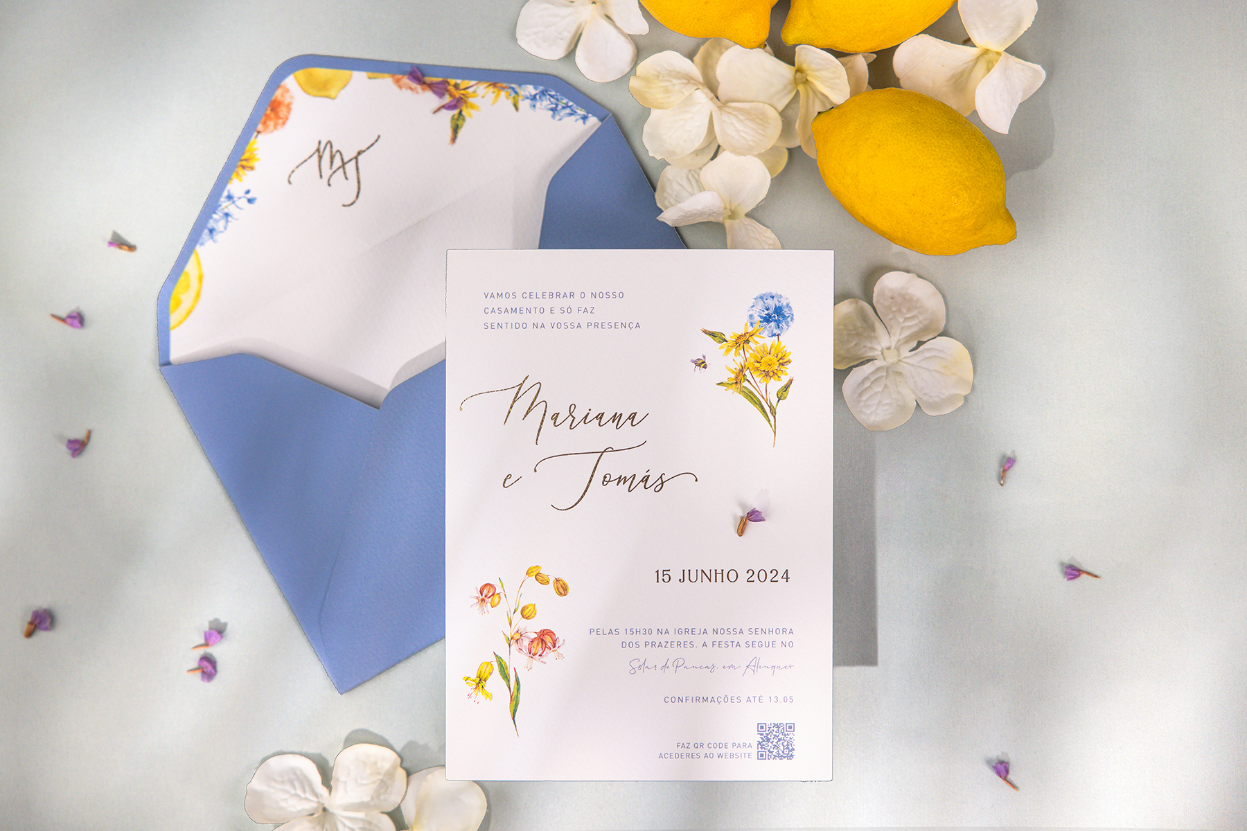 Convite de casamento com detalhes florais e envelope azul